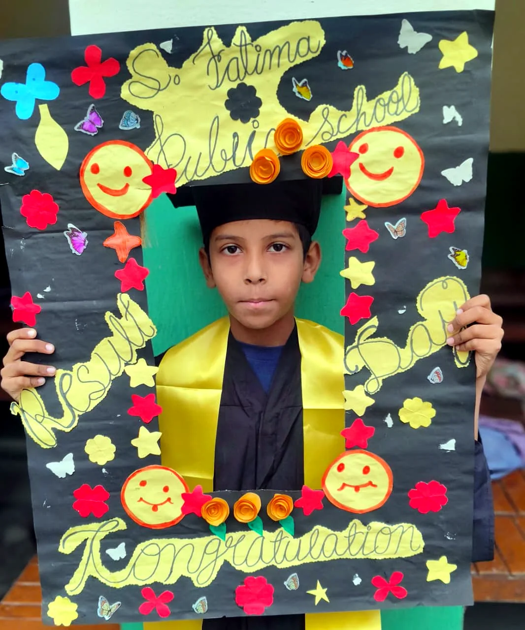 A student holds a decorated school project.