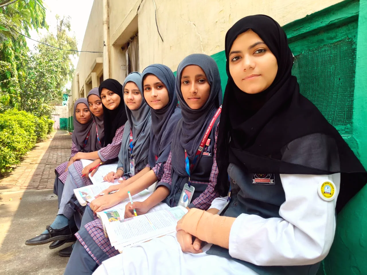 Students sitting together outdoors during a school activity.