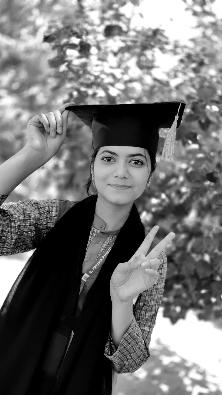 A student in graduation attire celebrating an academic milestone.