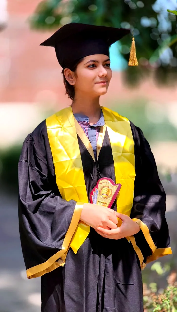 A student in graduation gown and cap.
