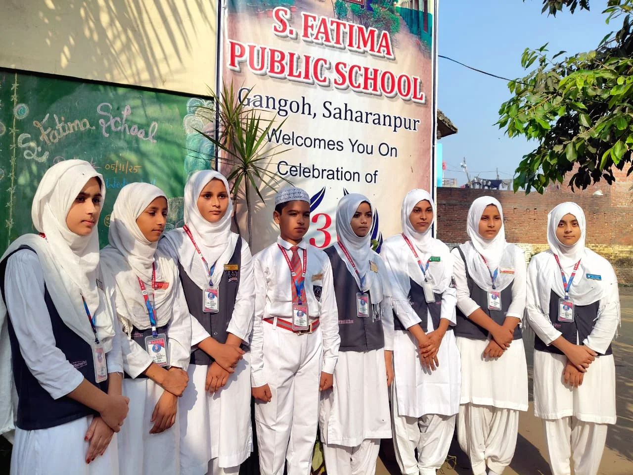 Students standing beneath the S. Fatima Public School event banner.