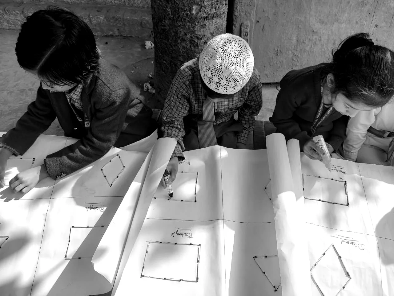Students work together on a large paper-based learning activity.
