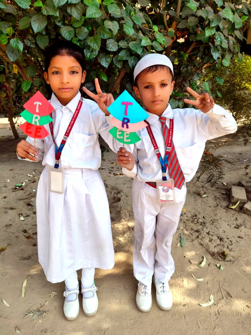 Young students display a tricolour-themed classroom project.